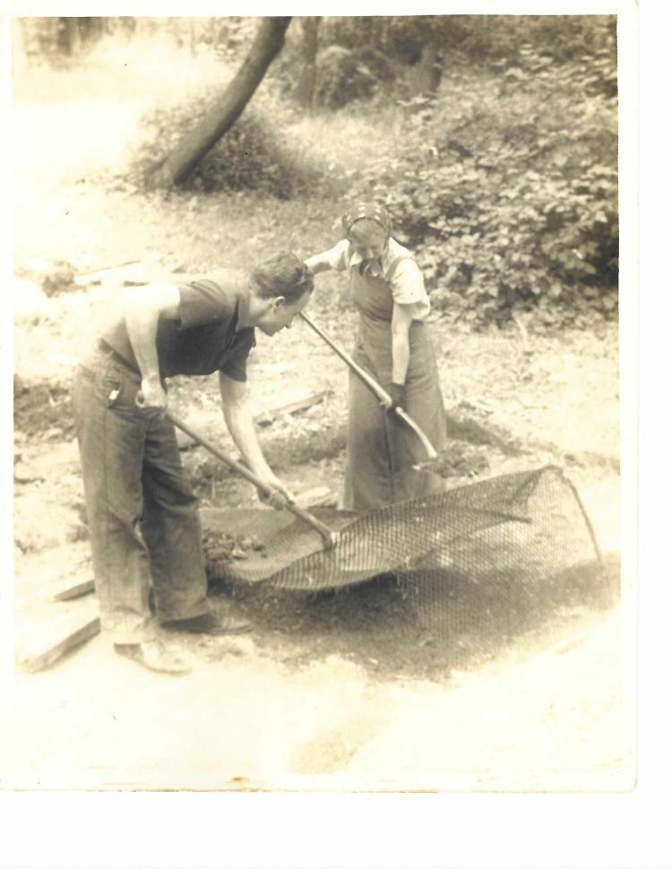 Robert Schnepfe Shaull and Clara Jane Shaull nee Laughlin, parents of the author, appear to be screening rocks out of dirt. About 1940.